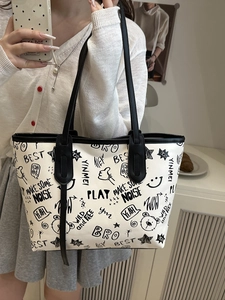 White contrast graffiti tote bag with black letter prints and shoulder strap for women