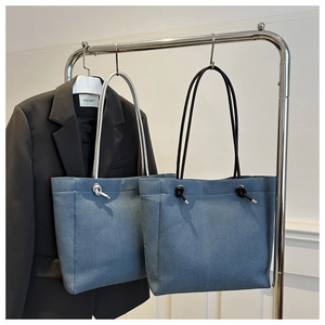 Minimalist denim tote bag with stylish knot straps for 2024 casual commute fashion