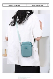 Detail view of the mint green crossbody phone bag with adjustable nylon shoulder strap