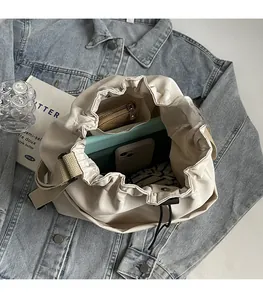 Top view of large beige bucket bag interior showing spacious storage for daily essentials