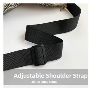 Detail view of the adjustable black nylon shoulder strap on the geometric tote bag
