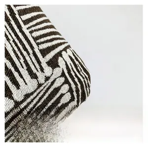 Close-up of premium thick knit jacquard fabric with brown and white geometric patterns