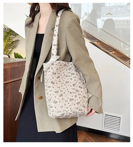 Floral tote bag with white lace bow detail and vintage flower pattern on quilted fabric