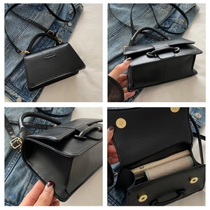 Detail view of black matte leather bag showing strap, interior space and golden hardware