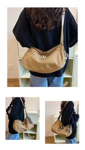 Detail van kaki nylon halve maan crossbodytas met konijntje en dambord bedel