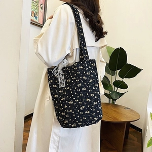 Quilted floral tote bag with yellow flowers and white lace bow detail for casual style