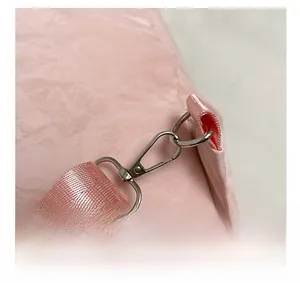 Detailed close-up of pink textured bag with high-quality silver metallic swivel hook