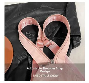 Detail showing adjustable pink woven strap with silver metal buckle on a small backpack