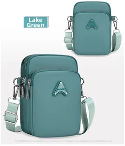 Detail of lake green multi-pocket phone bag with sport logo and adjustable strap