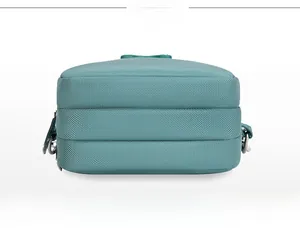 Detailed back and bottom view of teal nylon crossbody bag with multi-layer zippers