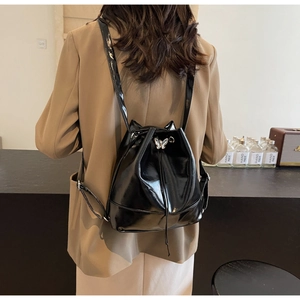 Détail du sac à dos seau noir brillant avec oreilles de chat et fermoir papillon argenté
