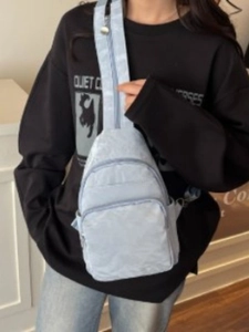 Minimalist light blue crossbody chest bag with multi-layer zippers and nylon fabric