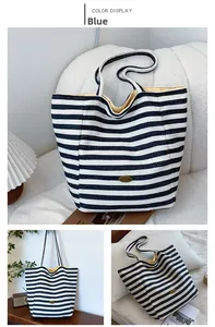 Detail of blue striped canvas tote bag showing yellow lining and metal brand logo