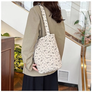 Detail showing the floral quilted texture and shoulder strap of the casual tote bag
