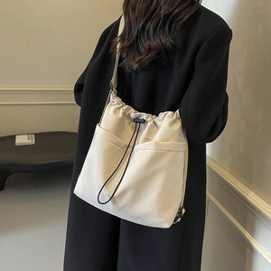 Minimalist cream drawstring bucket bag with adjustable strap for casual daily use