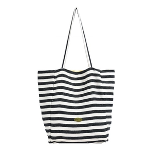 Classic black and white striped canvas tote bag with dual straps and handmade metal plate