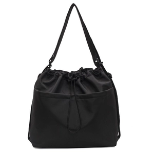 Minimalist black drawstring bucket bag with adjustable wide strap and large pocket