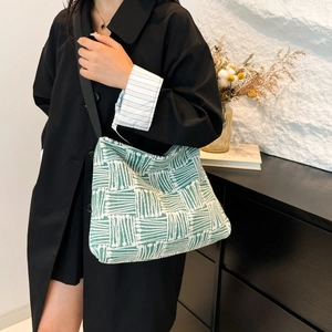 Minimalist forest green geometric tote bag with wide black shoulder strap for women