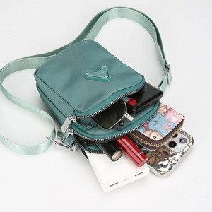 Three zippered compartments showing large storage capacity for phone and essentials