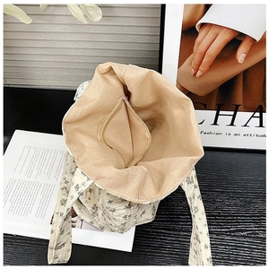 Top-down detail of the floral fabric tote bag showing its spacious inner lining and zip pocket