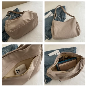 Detail view of large canvas shoulder bag with multi-pocket layout and high capacity