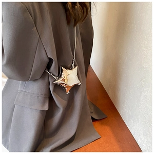 Silver star-shaped acrylic crossbody bag with a metallic finish and chain strap
