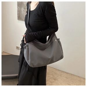 Large dark grey canvas bucket bag with adjustable wide strap for casual commuting