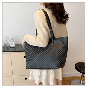 Detail view of a black geometric pattern tote bag showing the large capacity and texture