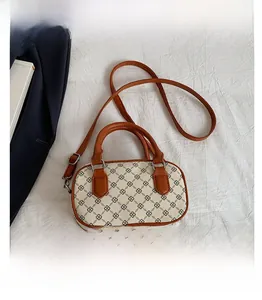 Detail view of mini square crossbody bag showing size comparison with a smartphone