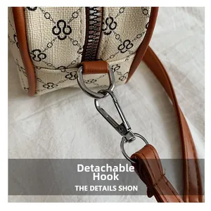 Detail view of detachable metal hooks and silver zipper on the vintage crossbody bag