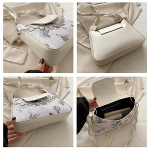Detailed views of a white butterfly print shoulder bag with silver chain and inner pocket