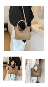 Detailed macro view of pebble grain leather and circular handle on khaki crossbody bag