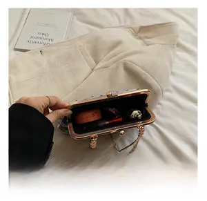 Detailed interior of vintage shell bag showing space for lipstick and makeup compact