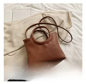 Detailed macro view of the brown lychee pattern leather texture on a stylish handbag