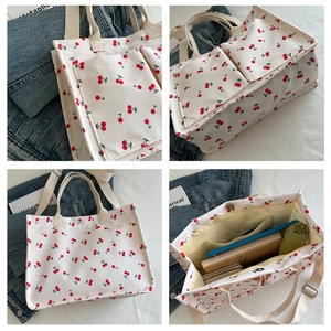 Detail showing spacious interior of white cherry print canvas tote bag with outer pockets