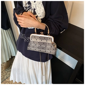 Detail of vintage grey plaid handbag with white lace trim and gold ball clasp