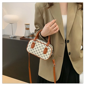Detailed view of vintage Boston bag with geometric floral pattern and adjustable strap