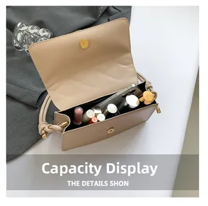 Detail view of the beige leather handbag interior showing daily essentials and capacity