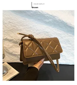 Detailed view of the brown quilted PU leather shoulder bag with a unique knot-decorated strap