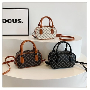 Three retro mini Boston handbags in cream, brown and black with geometric patterns