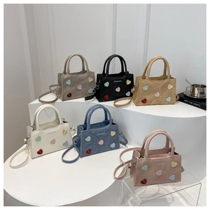Detailed group view of colorful leather handbags with fashion logo and heart decorations