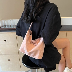 Pink pleated tote bag with bow detail and cloud-like shape for student casual wear