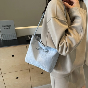 Light blue minimalist tote bag with bow detail and textured fabric for women