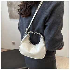 Detail of a beige crescent bag with silver chain and FASHION & BAGS LEATHER print