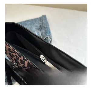 Detail view of leopard print tote bag with smooth black zipper and silver metal puller