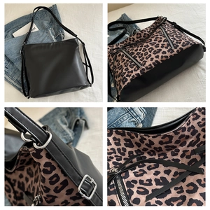 Detail view of large shoulder bag featuring leopard print panels and silver zippers