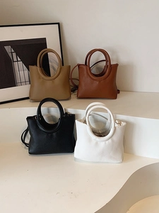 Minimalist faux leather tote bag in four colors with circular handle and thin strap