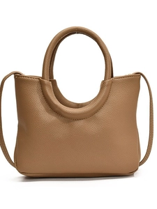 Minimalist camel brown hobo bag in lychee pattern leather with circular handle and strap