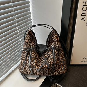 Large leopard print tote bag with metal zippers, bow detail and black leather straps