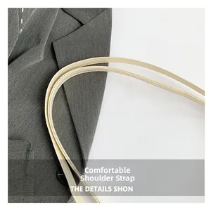 Close-up of comfortable PU leather shoulder straps with neat stitching on a beige tote bag